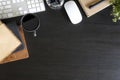 Top view workspace with book and pen coffee cup, computer keyboard with book on black office desk work wooden texture. Royalty Free Stock Photo