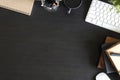 Top view workspace with book and pen coffee cup, computer keyboard with book on black office desk work wooden texture. Royalty Free Stock Photo