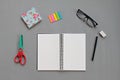 Top view of workspace desk with blank notebook and office stationery set on gray background Royalty Free Stock Photo