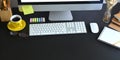 Top view workspace keyboard and mouse putting on black wooden working desk.