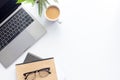 Top view workspace ,laptop on white table with coffee cup and notebook Royalty Free Stock Photo