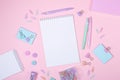 Top view of workspace with notepad and stationery accessories on pink background. Back to school concept Royalty Free Stock Photo