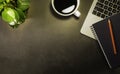 Top view of Workspace office desk, Black top table with laptop notebook, pencil and white cup of black coffee. Royalty Free Stock Photo