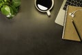 Top view of Workspace office desk, Light lamp, Black dark top table with laptop notebook, earphone, pencil and white cup of black Royalty Free Stock Photo