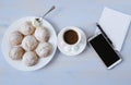 Top view of a workspace with a phone, a cup of coffee, cookies and a notebook with copy space Royalty Free Stock Photo