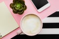 Top view of workspace with smartphone, cup of coffee and copy space on pink background Royalty Free Stock Photo