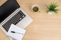 Top view of workspace. Table desk with laptop, coffee, notepad, pen and plant with empty space background for design. Royalty Free Stock Photo