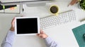 Top view workspace tablet holding on a man hands with above of table office desk.