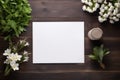 A top view of the workspace with a white empty card centered on the dark wooden background