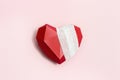 Top view with wounded heart red. Bandaged polygonal paper heart on pink background Royalty Free Stock Photo