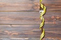 Top view of wrapped fork in tape measure on wooden background. Healthy eating and diet concept Royalty Free Stock Photo