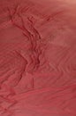 Top view of wrinkles on an unmade bed sheet after waking up in the morning Royalty Free Stock Photo