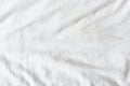 Top view of wrinkles on an untidy white bed sheet in a bedroom. Royalty Free Stock Photo