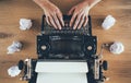 Close up of writer prints on vintage typewriter with crumpled papers around