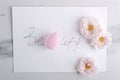 Top view of written wird Beauty, pink cosmetic sponge and roses on the marble surface Royalty Free Stock Photo