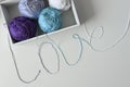 Top view of yarn balls in a wood box. Love word designed from colorful knitting wools threads. Royalty Free Stock Photo