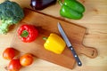 Top View of Yellow Bell Pepper on Cutting Board with Knife and Another Vegetables Scattered Around Royalty Free Stock Photo