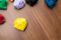 Top view of yellow crumpled paper ball on dark brown wood table Royalty Free Stock Photo