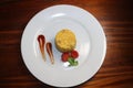 Top view of Yellow Cup rice decoration with tomato sauce and make tomato flower on white plate on table Royalty Free Stock Photo