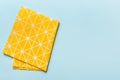 top view with yellow empty kitchen napkin isolated on table background. Folded cloth for mockup with copy space, Flat Royalty Free Stock Photo