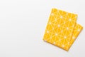 top view with yellow empty kitchen napkin isolated on table background. Folded cloth for mockup with copy space, Flat Royalty Free Stock Photo