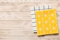 top view with yellow empty kitchen napkin isolated on table background. Folded cloth for mockup with copy space, Flat Royalty Free Stock Photo