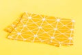 top view with yellow empty kitchen napkin isolated on table background. Folded cloth for mockup with copy space, Flat Royalty Free Stock Photo