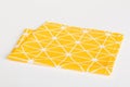 top view with yellow empty kitchen napkin isolated on table background. Folded cloth for mockup with copy space, Flat Royalty Free Stock Photo