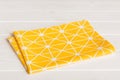 top view with yellow empty kitchen napkin isolated on table background. Folded cloth for mockup with copy space, Flat Royalty Free Stock Photo