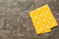 top view with yellow empty kitchen napkin isolated on table background. Folded cloth for mockup with copy space, Flat Royalty Free Stock Photo