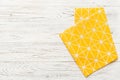 top view with yellow empty kitchen napkin isolated on table background. Folded cloth for mockup with copy space, Flat Royalty Free Stock Photo