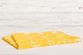 top view with yellow empty kitchen napkin isolated on table background. Folded cloth for mockup with copy space, Flat Royalty Free Stock Photo