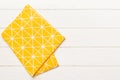 top view with yellow empty kitchen napkin isolated on table background. Folded cloth for mockup with copy space, Flat Royalty Free Stock Photo