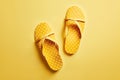 Top view of yellow flip flops on yellow flat background. Generative AI