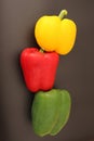 Top view of yellow green red bell peppers stacked on black background. Royalty Free Stock Photo