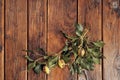 A top view of yellow hand painted easter eggs decorated with green ivy branches on a vintage, wooden table with space Royalty Free Stock Photo