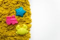 Top view yellow kinetic sand with molds. Magic sand for children. Selective focus