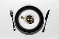 Top view of yellow measuring tape on black plate with knife and fork isolated on grey background. Royalty Free Stock Photo