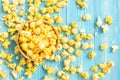 Top view yellow popcorn on blue wooden plank background Royalty Free Stock Photo