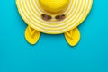 Top view of yellow sunglasses, striped retro hat and flip-flops Royalty Free Stock Photo