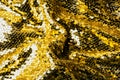 top view of yellow textile with shiny sequins