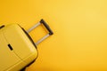 Top view yellow travel bag or suitcase on solid yellow background copy space. Tourist essentials Royalty Free Stock Photo