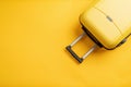 Top view yellow travel bag or suitcase on solid yellow background copy space. Tourist essentials Royalty Free Stock Photo