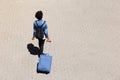 Top view young afro american woman walking on the street with luggage