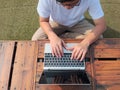 Top view of  young Asian man using computer laptop at outdoors. Internet of things concept Royalty Free Stock Photo