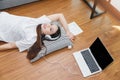 Top view of young beautiful asian woman with headphone and listening music from laptop while lying on the floor at home Royalty Free Stock Photo