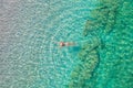 Top view. Young beautiful naked woman in a hat swimming in sea water on sand beach. Drone, copter photo. Summer vacation. View fro Royalty Free Stock Photo