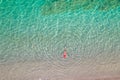 Top view. Young beautiful woman in a red hat and bikini swimming in sea water on the sand beach. Drone, copter photo. Summer Royalty Free Stock Photo