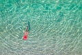 Top view. Young beautiful woman in a red hat and bikini swimming in sea water on the sand beach. Drone, copter photo. Summer Royalty Free Stock Photo