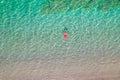 Top view. Young beautiful woman in a red hat and bikini swimming in sea water on the sand beach. Drone, copter photo. Summer Royalty Free Stock Photo